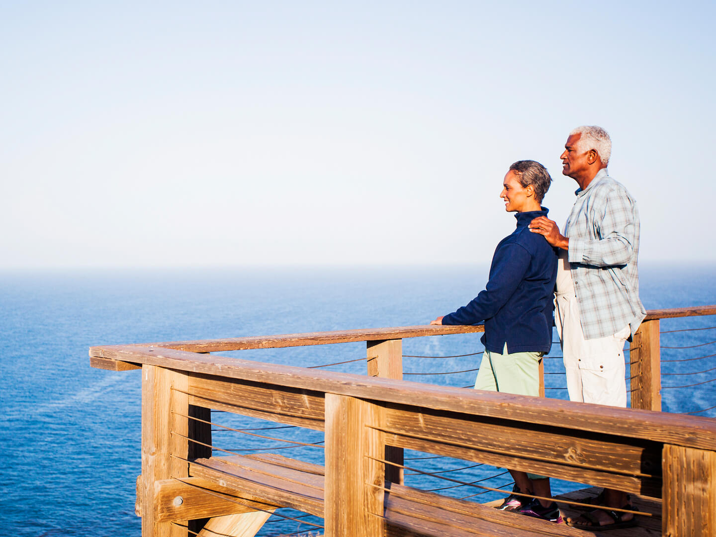 How Webster protects you - older couple standing on pier looking out into ocean