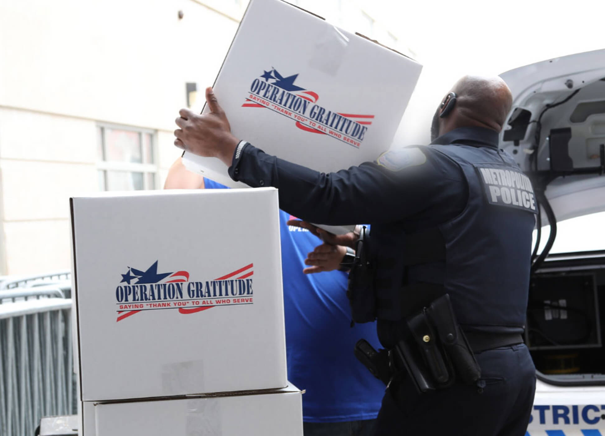 police officer loading Operation Gratitude donations into car