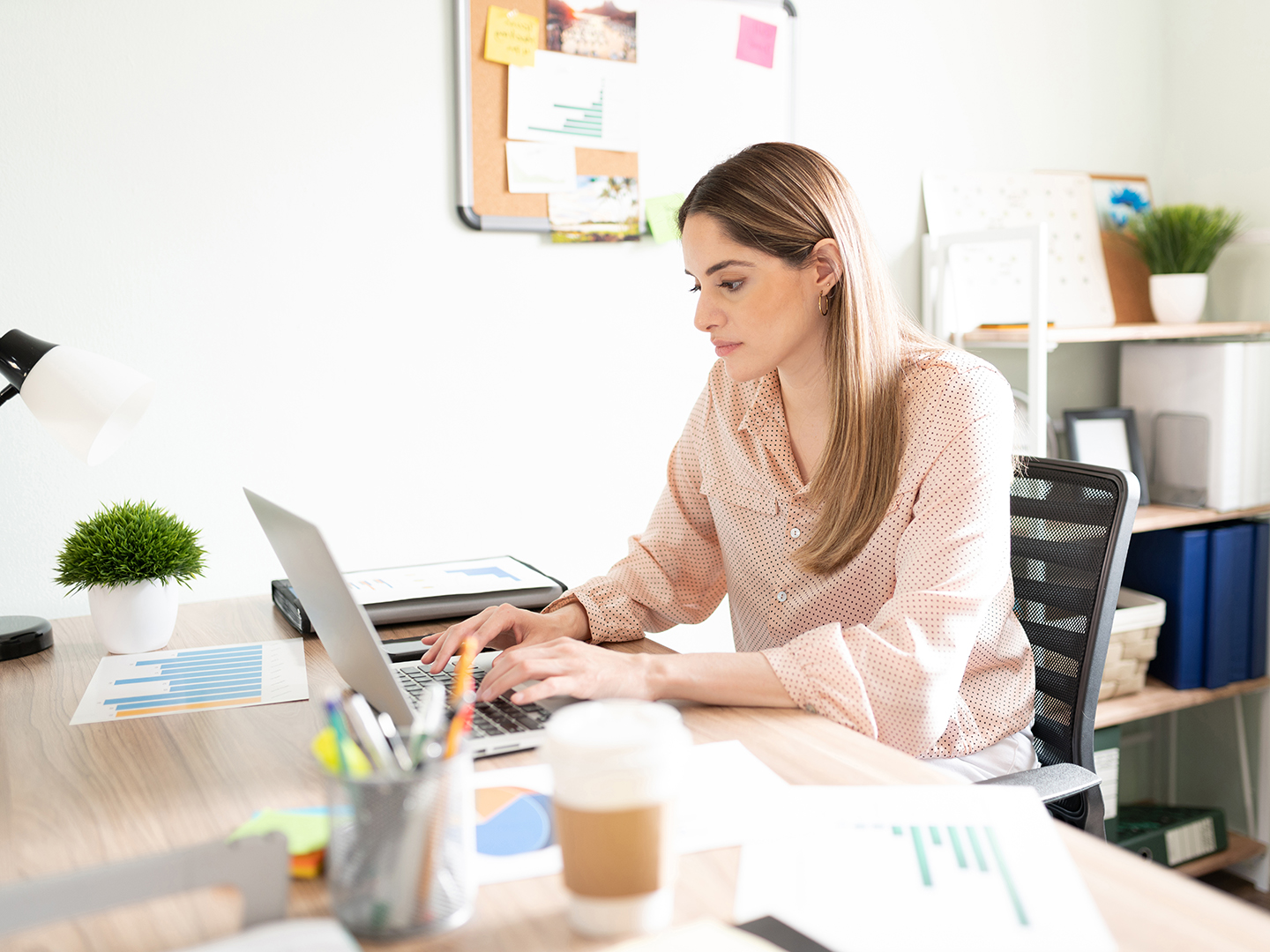 woman sitting at desk using a laptop